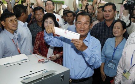 Cambodian Prime Minister Hun Sen at a ballot box during last month’s election, in which his party won every seat after the main opposition had been dissolved by court order. Photo: AP