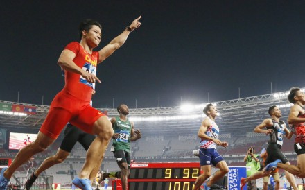 Su Bingtian raises his hand in triumph after winning the 100 metres. Photo: Kyodo
