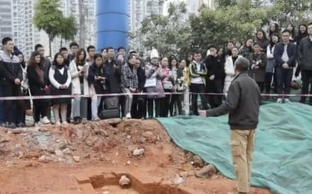 Students at Guangzhou’s Sun Yat-sen University listen to an archaeology lecture beside the tombs discovered on campus. Photo: Guancha.cn