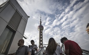 Pedestrians ride an escalator near the Oriental Pearl Tower in the Lujiazui Financial District in Shanghai, China, on Monday, Sept. 4, 2017. The Chinese central bank's tight leash on liquidity is straining the bond market, with the benchmark sovereign yield climbing to near the highest level since April 2015. Photographer: Qilai Shen/Bloomberg Pedestrians ride an escalator near the Oriental Pearl Tower in the Lujiazui Financial District in Shanghai, China, on Monday, Sept. 4, 2017. The Chinese central bank's tight leash on liquidity is straining the bond market, with the benchmark sovereign yield climbing to near the highest level since April 2015. Photographer: Qilai Shen/Bloomberg