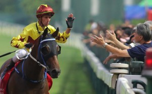 Nash Rawiller gives a fan a high-five after Southern Legend’s win at Happy Valley on Sunday. Photos: Kenneth Chan