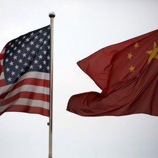 US and Chinese national flags fly outside a building in the Waigaoqiao Free Trade Zone in Shanghai. Photo: Bloomberg
