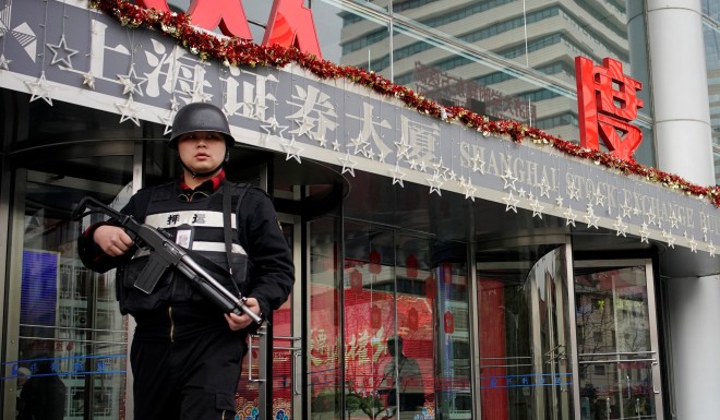 A security guard outside of the Shanghai Stock Exchange building.