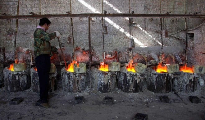 A Chinese worker smelts rare earth metals. China dominates the global supply of these materials, which have widespread applications in military tech.