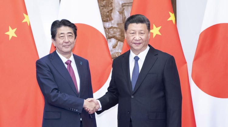 Chinese President Xi Jinping (right) shakes hands with visiting Japanese Prime Minister Shinzo Abe in Beijing on Friday. Photo: Xinhua