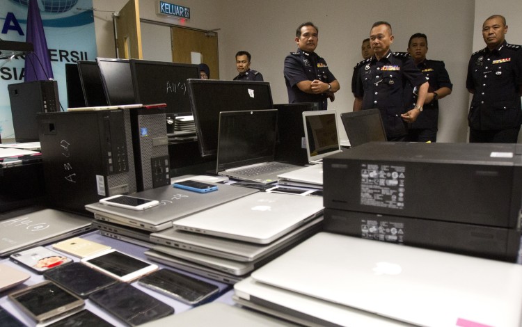 Malaysian police arrested 93 Chinese and six locals in a raid on a suspected telephone scam operation in Kuala Lumpur on Frday. Photo: AP