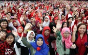 Indonesian domestic helpers cheer at an event to meet Indonesian President Joko Widodo at AsiaWorld-Expo, on April 30. Photo: Edward Wong