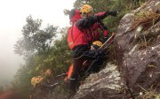 Rescue team members carry the injured woman up Kowloon Peak. Photo: Handout