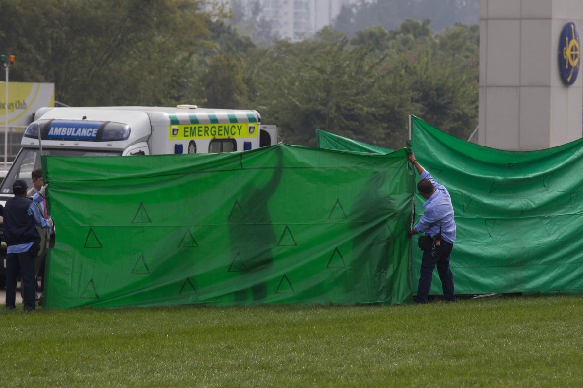 Jockey Club staff put up a screen as paramedics attend to injured jockey Steve Drowne and vets assist English filly Jwala after the fall in the Hong Kong Sprint. Photo: Reuters  