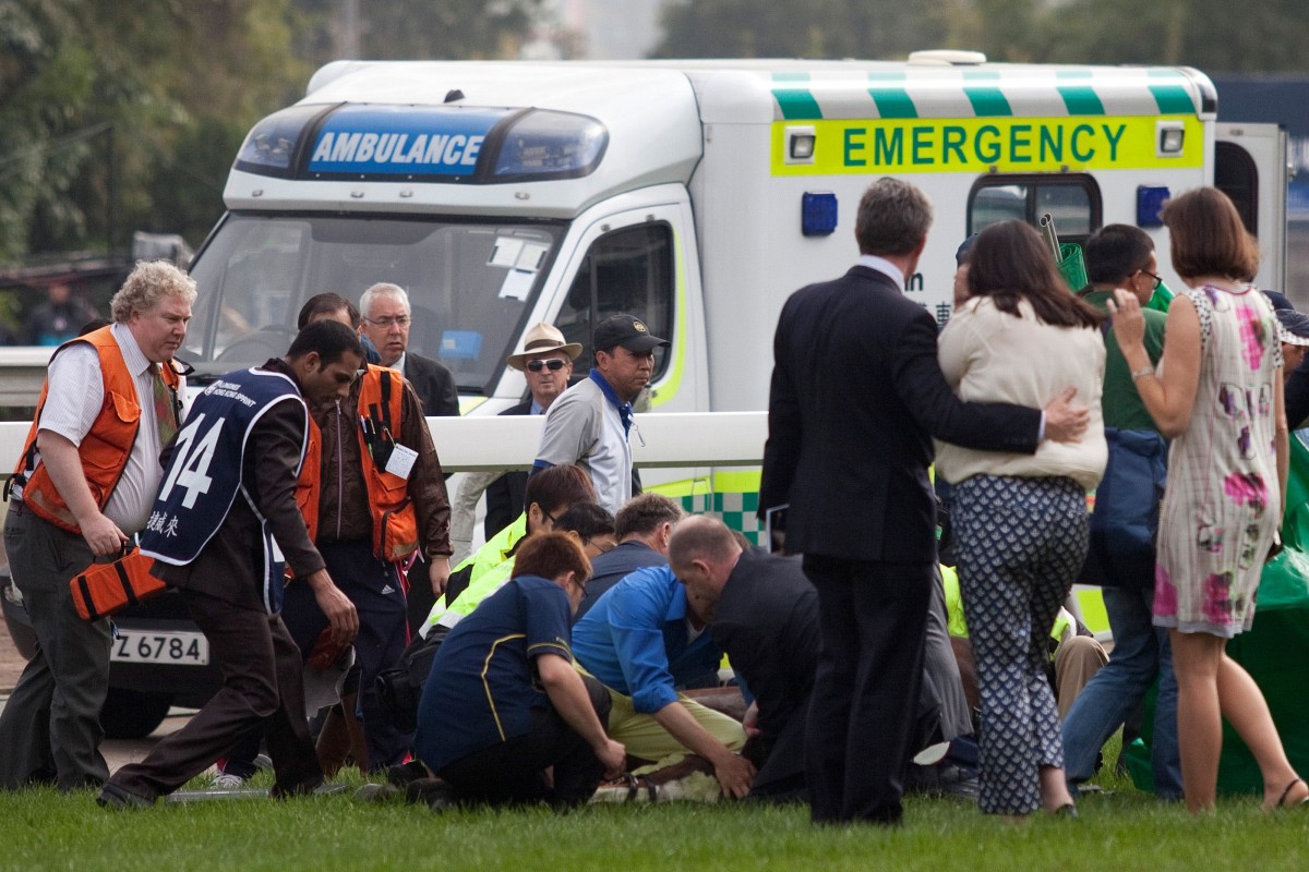 Emergency services and racecourse staff attend to Steve Drowne and Jwala after their fall near the winning post in the Longines Hong Kong Sprint. Photo: Kenneth Chan