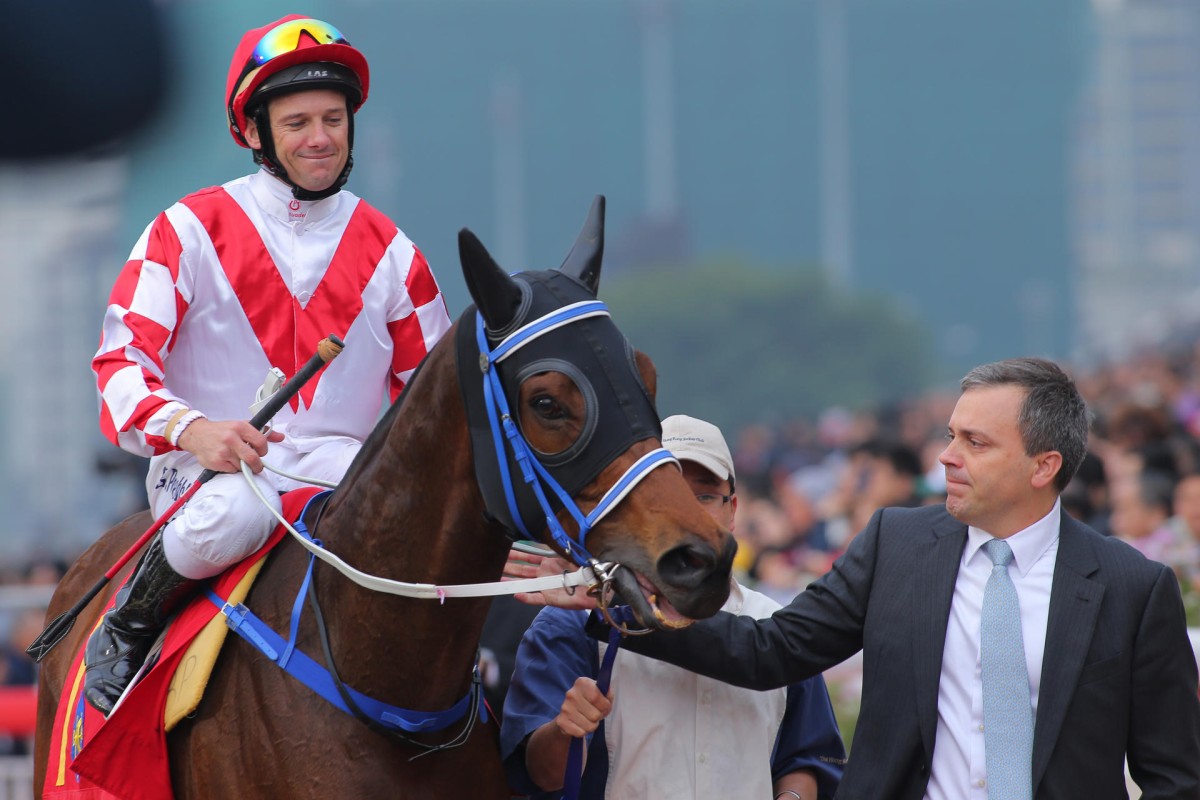 Caspar Fownes and Brett Prebble show their admiration for Lucky Nine after his tenacious victory in the Chairman's Sprint Prize. Photo: Kenneth Chan