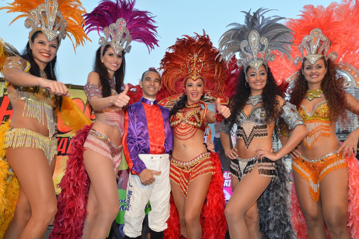 Joao Moreira - pictured with samba dancers at Happy Valley on Wednesday night - can score another victory in Sunday's Jockey Challenge. Photo: Kenneth Chan