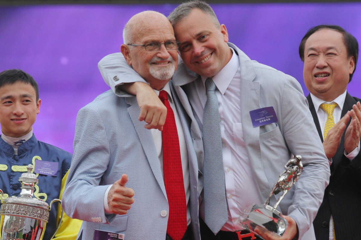 Caspar Fownes (right) hugs his father and former Hong Kong trainer Lawrence after winning the 2013-14 trainer's championship, his third triumph. Photos: SCMP Pictures