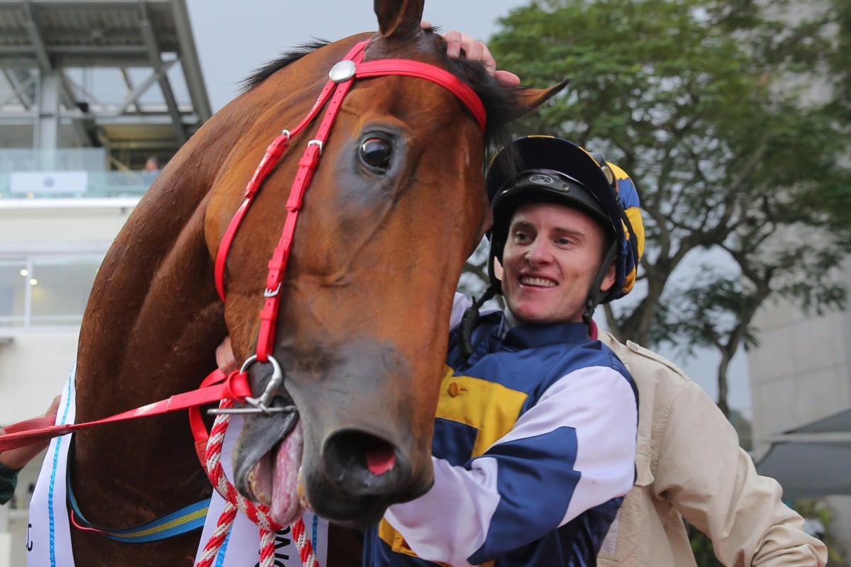 Zac Purton gives Luger a pat after winning the Hong Kong Derby. Photo: Kenneth Chan