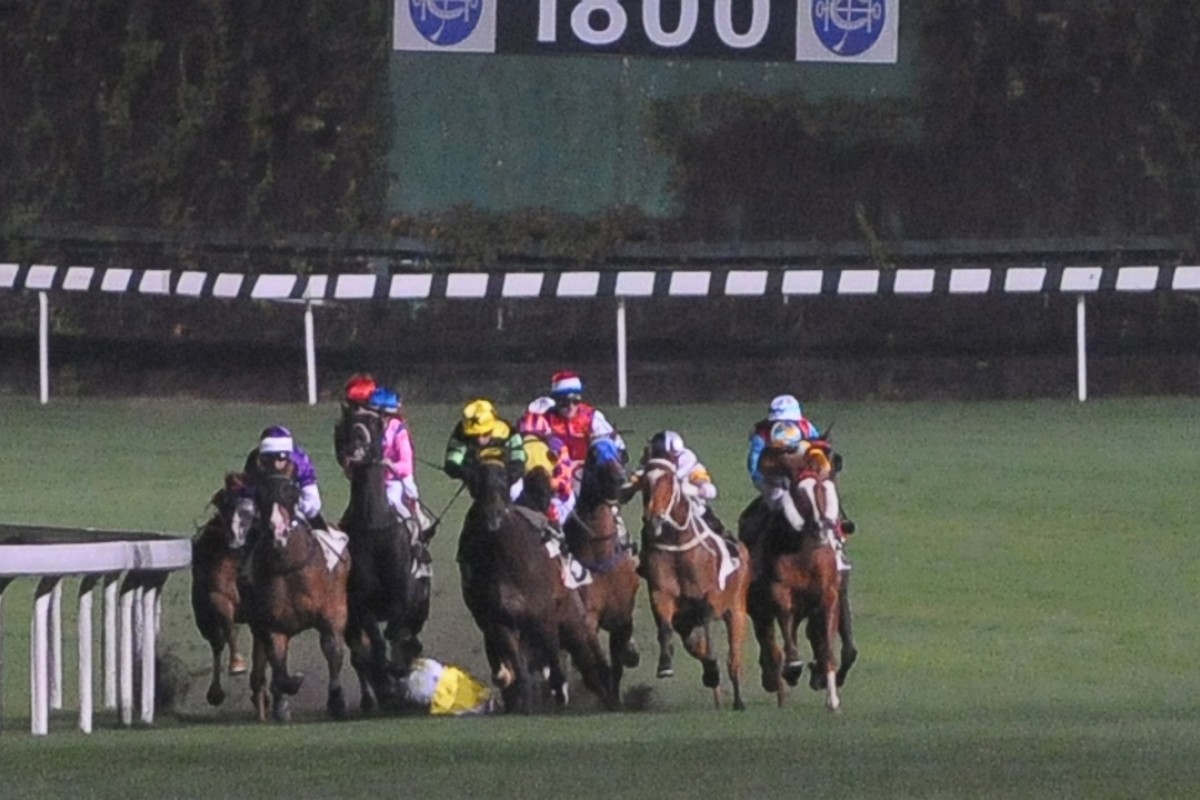 Joao Moreira falls and is run over by horses in the first race at Happy Valley, but escapes serious injury. Photos: Kenneth Chan