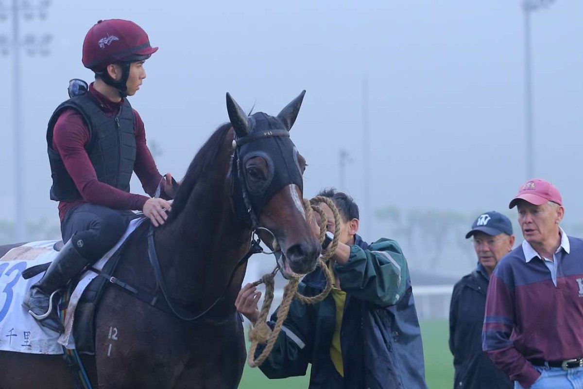 Rider Thomas Yeung gets instructions from trainer John Moore before taking Hong Kong Derby winner Werther for his final gallop ahead of Sunday’s Audemars Piguet QE II Cup. Photo: Kenneth Chan