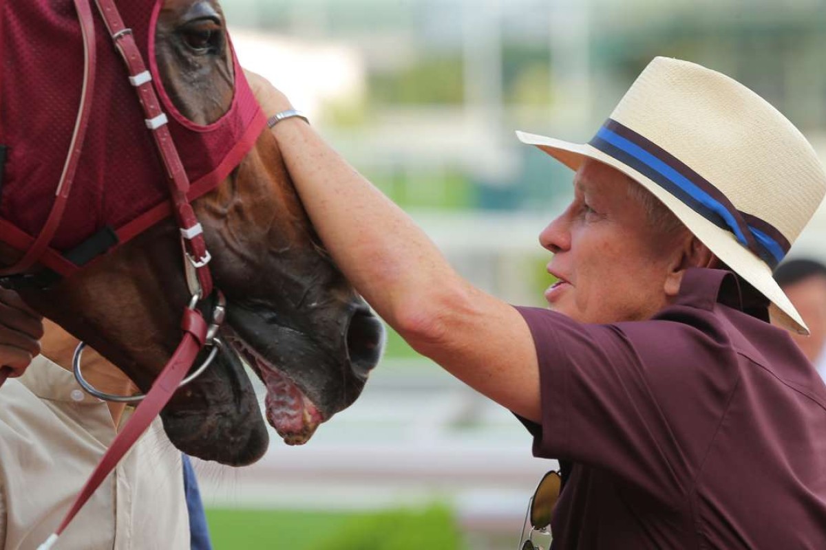 John Moore gives Rapper Dragon a pat after his win in the Lion Rock Trophy on Sunday. Rapper Dragon will spearhead Moore’s Derby team next season. Photo: Kenneth Chan