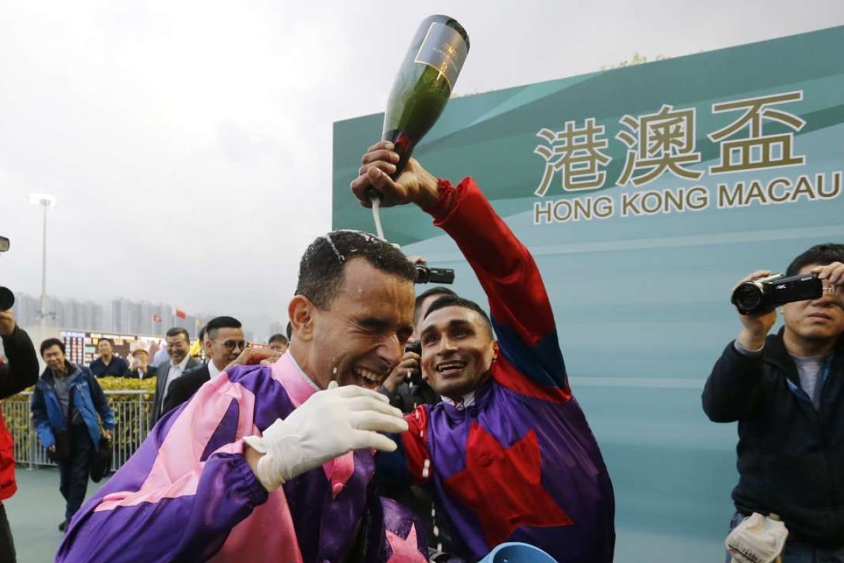 Joao Moreia is doused by champagne by fellow jockey Karis Teetan after notching his eighth win of the day aboard Prawn Baba. Photos: Kenneth Chan