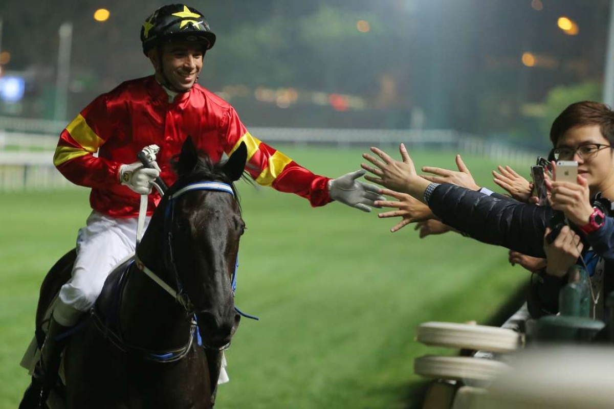 Joao Moreira poses for a selfie with a fan after winning aboard Marvel Hero at Happy Valley on Wednesday night. Photos: Kenneth Chan