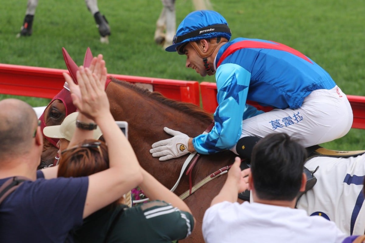 Rapper Dragon gets patted by Joao Moreira and applause from the fans after winning the Group Two Chairman’s Trophy. Photos: Kenneth Chan