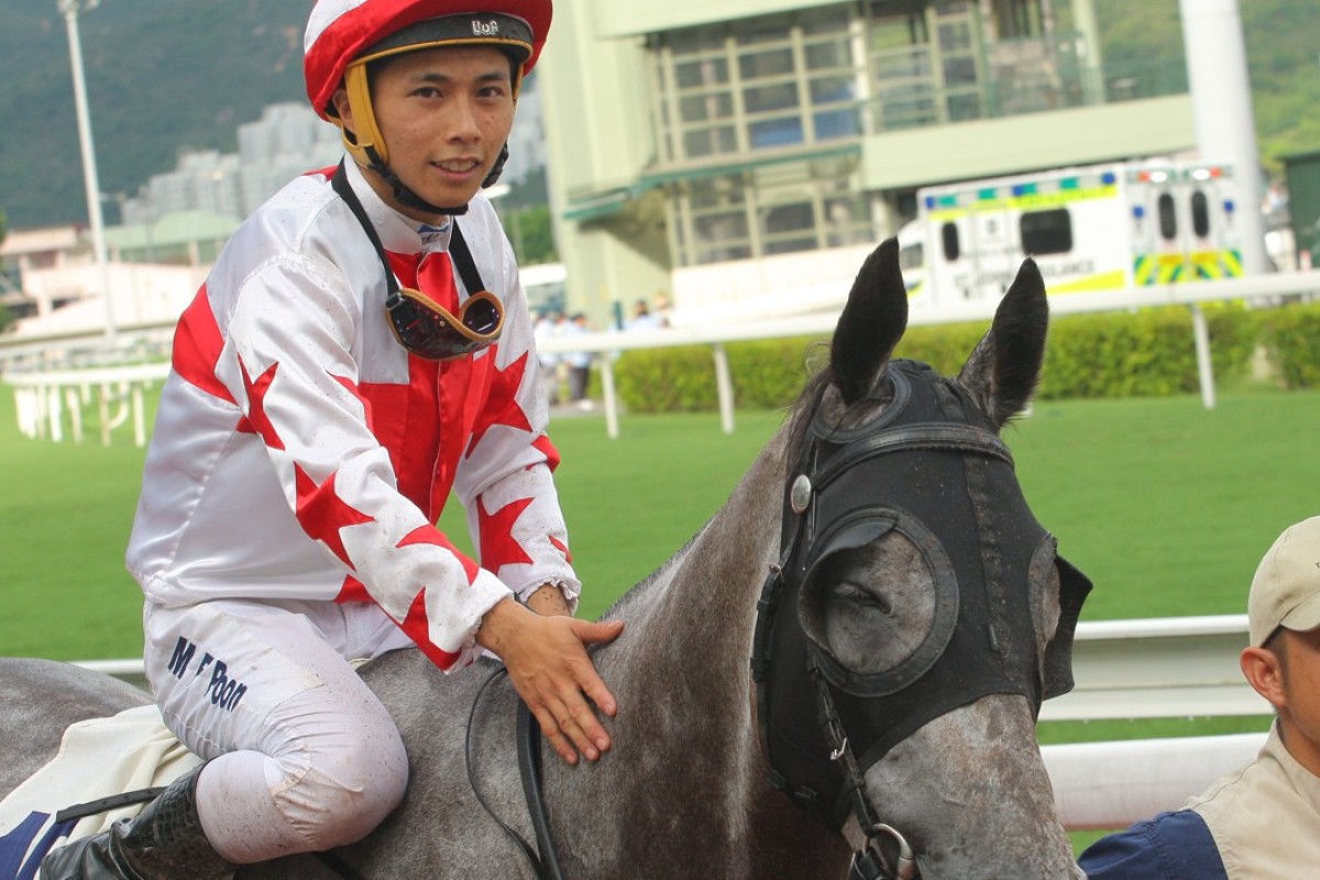 Matthew Poon gives Hard Ball Get a pat after notching his 20th winner in Hong Kong. Photos: Kenneth Chan