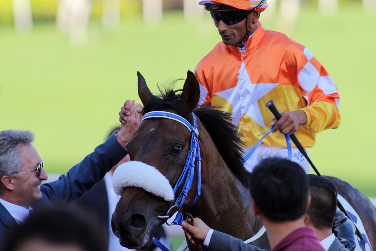 Karis Teetan shakes hands with trainer David Ferraris after completing a treble aboard Amazing Agility. Photos: Kenneth Chan