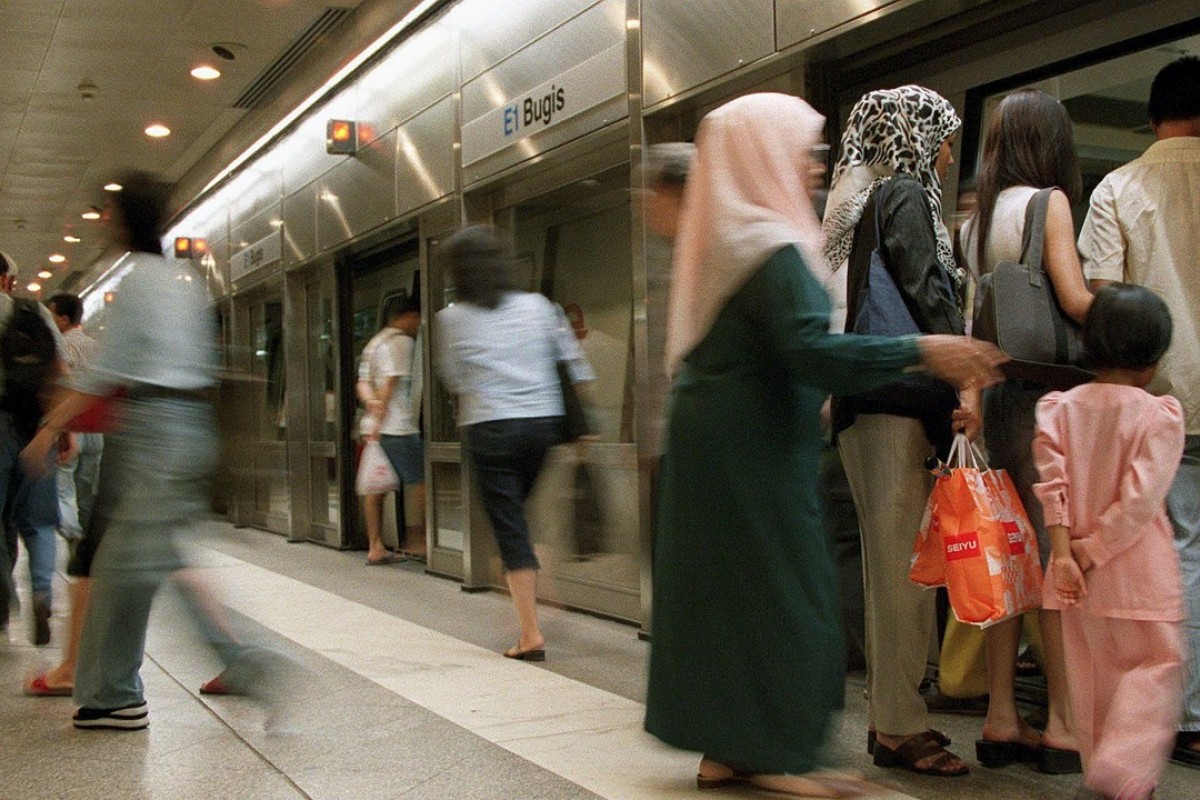 Passengers board a Singapore Mass Rapid Transit train. Photo: AFP