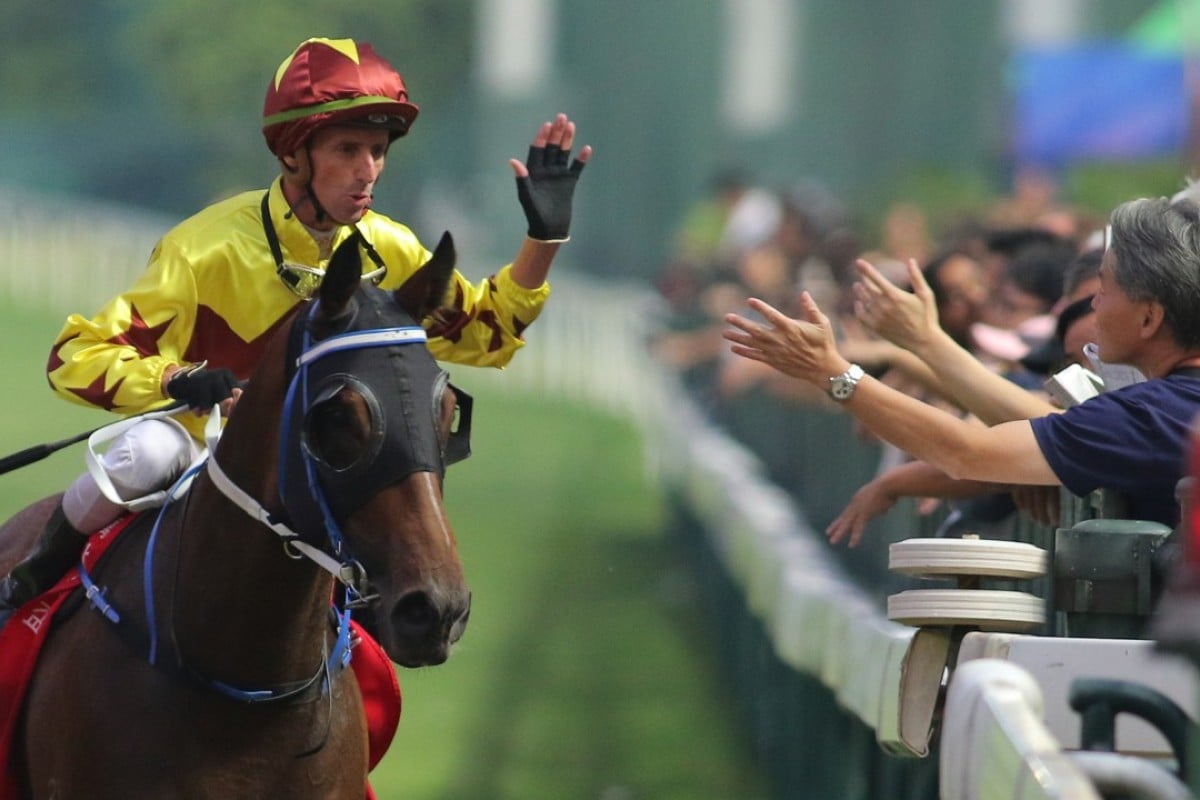 Nash Rawiller gives a fan a high-five after Southern Legend’s win at Happy Valley on Sunday. Photos: Kenneth Chan