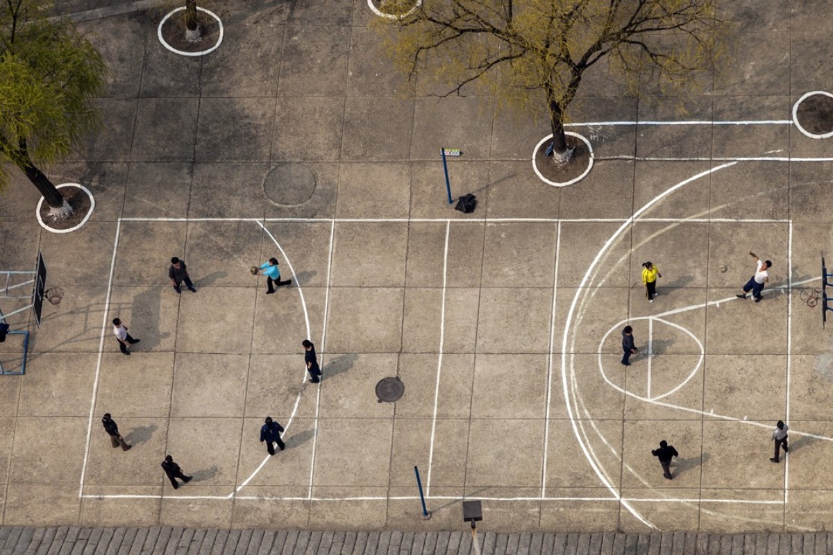 Staff at Pyongyang’s Yanggakdo Hotel make use of the basketball court during their evening break. Situated on an island, the hotel is one of the few where foreign visitors are permitted to stay in Pyongyang.