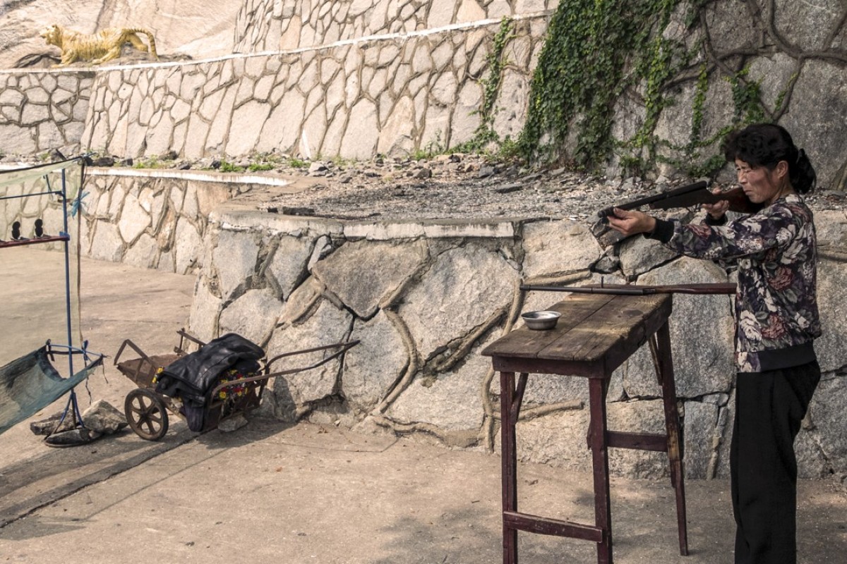 A worker prepares a gun at a rifle range at the base of the 130-metre-high Suyangsan Waterfall, near Haeju, in South Hwanghae province. Korean won only is accepted here.