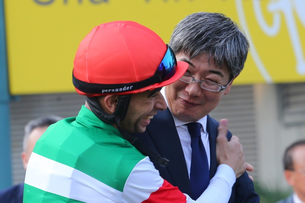 Joao Moreira celebrates with trainer Noriyuki Hori after winning the QE II Cup with Neorealism. Photos: Kenneth Chan