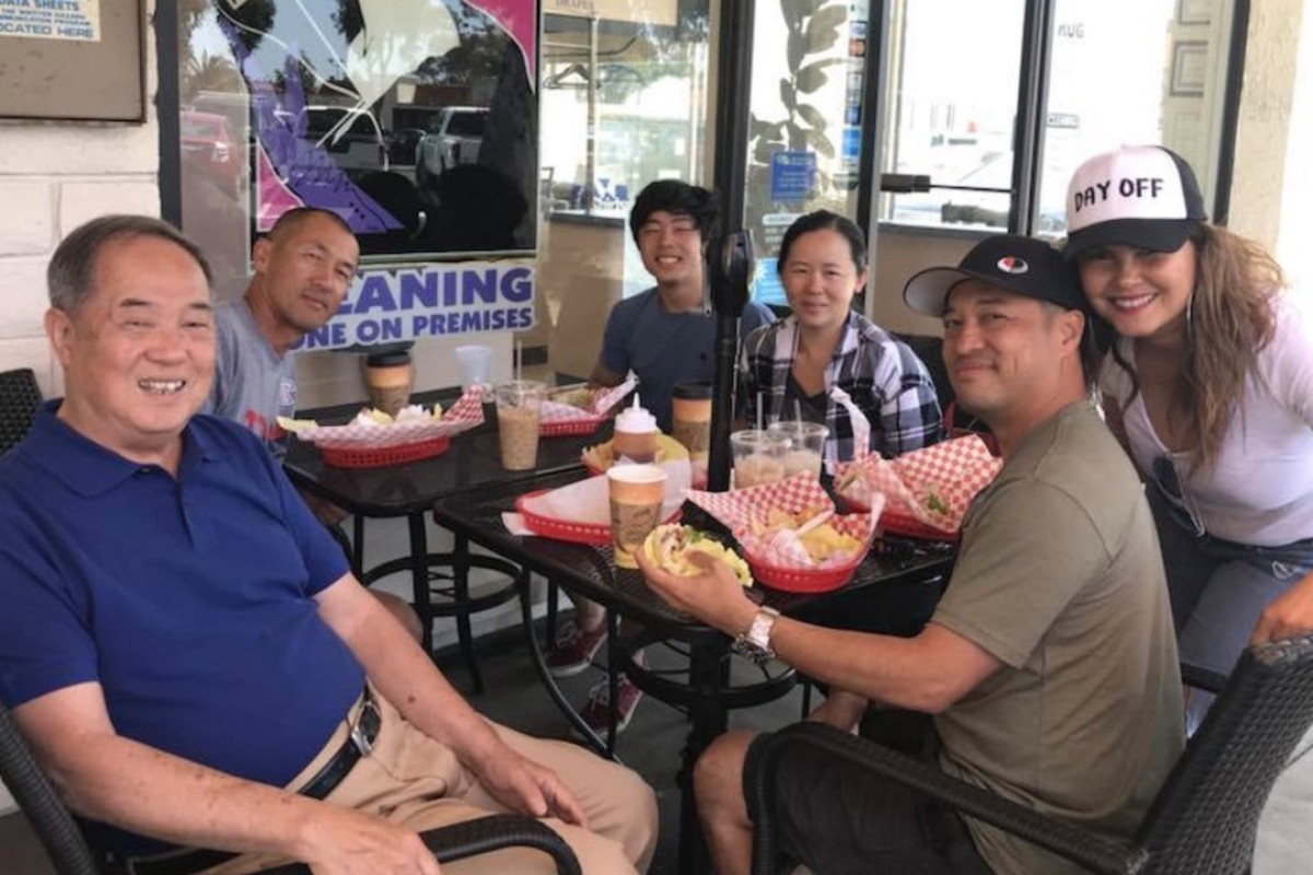 Ted Ngoy with relatives at a fast-food restaurant in Orange County. He came back to the United States to publicise his autobiography to the Cambodian community in California. Photo: Ted Ngoy