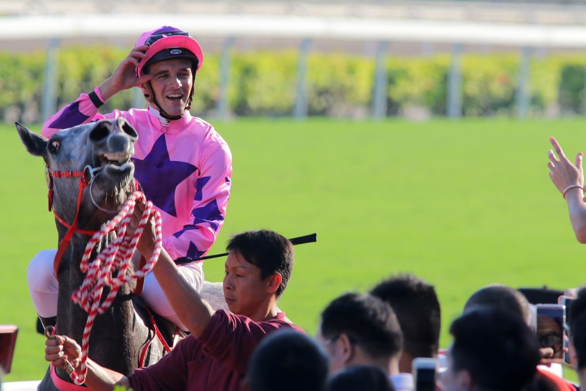 Sam Clipperton returns to scale after winning aboard Hot King Prawn. Photos: Kenneth Chan